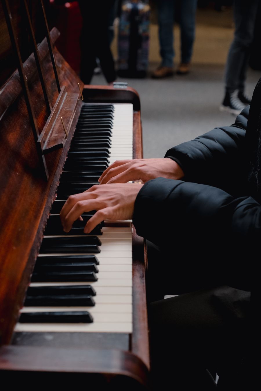 Hands playing piano keys